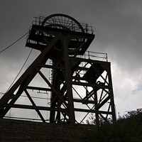 Buy canvas prints of Silhouette of abandoned pit head winding gear, South Wales by Gordon Dixon