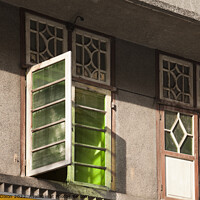 Buy canvas prints of Old green glass windows on an old 'colonial' house in Mumbai, India by Gordon Dixon