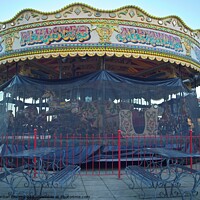 Buy canvas prints of Carousel and it's horses put to bed for the winter at a funfair in Weymouth by Gordon Dixon