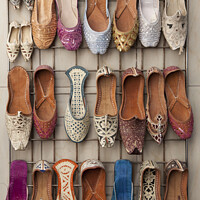 Buy canvas prints of Arabian slippers for sale at a Dubai souk by Gordon Dixon