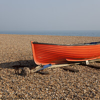 Buy canvas prints of Small red fishing boat on shingle on Brighton beac by Gordon Dixon