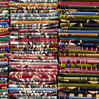 Buy canvas prints of Stacks of colourful Prayer Mats for sale at an Istanbul market by Gordon Dixon