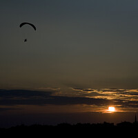 Buy canvas prints of Powered paraglider pilot soars over the skyline of Istanbul at sunset by Gordon Dixon