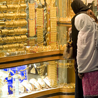 Buy canvas prints of 2 ladies shop for gold in the Dubai gold souk by Gordon Dixon