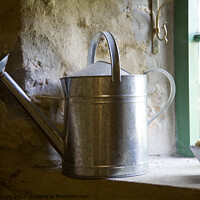 Buy canvas prints of A galvanised watering can sits on a windowsill by Gordon Dixon