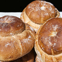 Buy canvas prints of Freshly baked cottage loaves on a baker's stall  by Gordon Dixon
