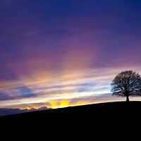 Buy canvas prints of Dramatic sunset behind Spir Hill with sunbeams by Gordon Dixon
