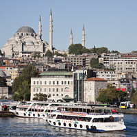 Buy canvas prints of Magnificent Suleymaniye Mosque towers over the Eminonu waterfront - Istanbul by Gordon Dixon