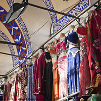 Buy canvas prints of Clothing stall inside Istanbul's ornate Grand Bazzar by Gordon Dixon