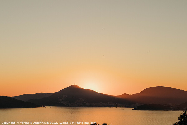 A sunset over a body of water, Montenegro  Picture Board by Veronika Druzhnieva