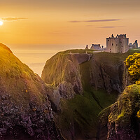 Buy canvas prints of Dramatic Dunnottar Castle Sunrise at Stonehaven by DAVID FRANCIS