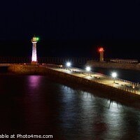 Buy canvas prints of Whitby Lighthouse and Pier Night Shot. by Craig Yates