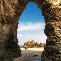 Buy canvas prints of Surfer Through The Arch by Craig Yates