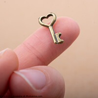 Buy canvas prints of Tiny key with heart shape on the finger tip by Turgay Koca