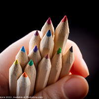Buy canvas prints of Hand holding colored pencils for creative idea and concept.  by Turgay Koca