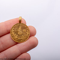 Buy canvas prints of Turkish Ottoman style gold coin in hand by Turgay Koca