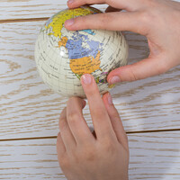 Buy canvas prints of Hand holding a globe  with the map on it by Turgay Koca