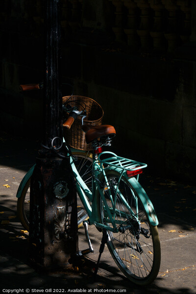 Vintage Style Turquoise Ladies Bicycle Locked to a an urban Lamp Post. Picture Board by Steve Gill