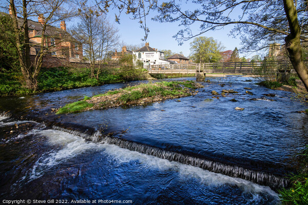 River Skell with a Small Weir and a Footbridge. Picture Board by Steve Gill