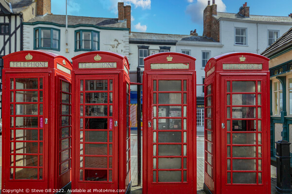 A Row of Four Red Traditional Telephone Boxes. Picture Board by Steve Gill