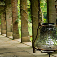 Buy canvas prints of Antique Looking Glass Lantern Hanging from a Rusty Chain.  by Steve Gill