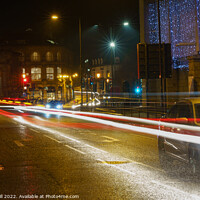 Buy canvas prints of During the Evening of a Rainy Night, a Yellow Taxi Travels Along a Wet Road. by Steve Gill