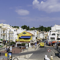 Buy canvas prints of Vibrant Carvoeiro Town Square Algarve by RJW Images