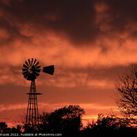 Buy canvas prints of Windmill silhouette with a Sunset by Robert Brozek