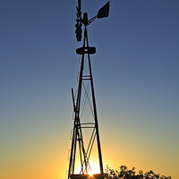Buy canvas prints of Kansas Windmill silhouette at Sunset by Robert Brozek