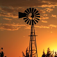 Buy canvas prints of  Farm Windmill at Sunset with clouds by Robert Brozek