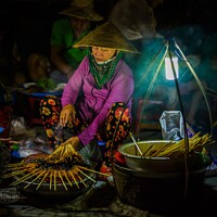 Buy canvas prints of Lady Cooking Street Food in Hoi An Vietnam by Paul Stearman