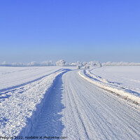 Buy canvas prints of View of a snow-covered country road in winter with sunshine and blue sky by Michael Piepgras