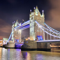 Buy canvas prints of The Tower Bridge in London at night with colorful lights by Michael Piepgras