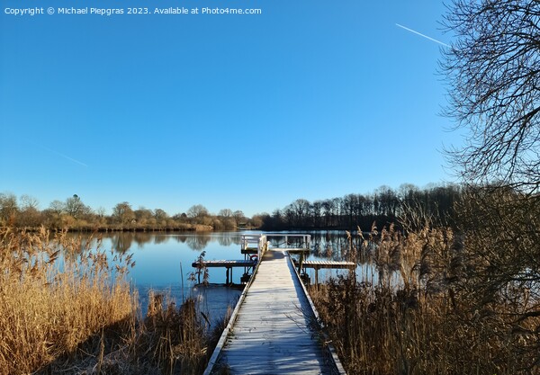 Beautiful landscape on a jetty by a lake with blue sky. Picture Board by Michael Piepgras