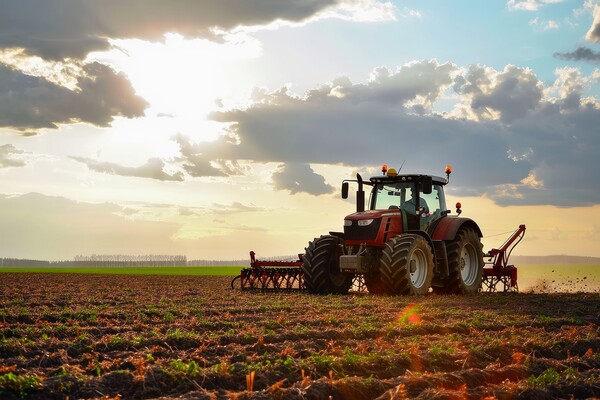 A large tractor working on a field with big machines. Picture Board by Michael Piepgras