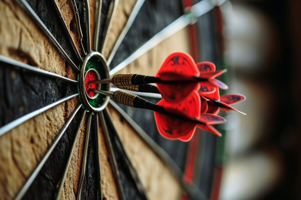 Three darts hitting perfect on the target bullseye. Picture Board by Michael Piepgras