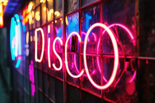 A colorful neon sign showing the word Disco on a wall of a club. Picture Board by Michael Piepgras