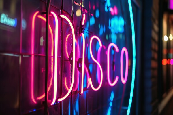 A colorful neon sign showing the word Disco on a wall of a club. Picture Board by Michael Piepgras
