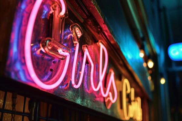 A colorful neon sign showing the word Girls on the wall of a clu Picture Board by Michael Piepgras