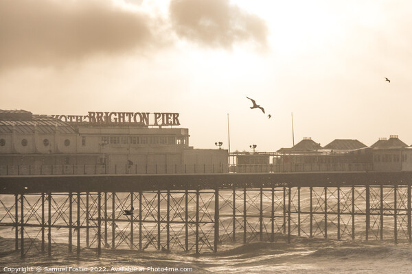 Brighton Pier on a stormy windy day with sun coming through clouds Picture Board by Samuel Foster