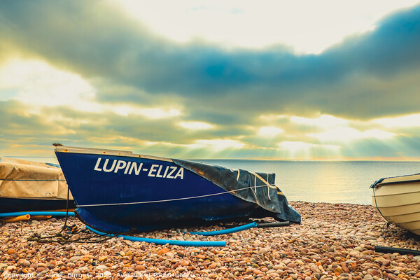 Boat on Budleigh Beach with Sun Rays Picture Board by Adrian Burgess