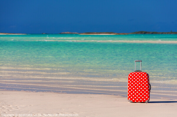 Red polka dot travel suitcase on sand beach Picture Board by Spotmatik 
