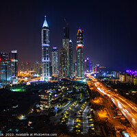 Buy canvas prints of Night Dubai illuminated view of modern city Skyscrapers by Spotmatik 