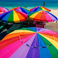 Buy canvas prints of Colorful beach umbrellas in the tropical sunshine Caribbean by Spotmatik 