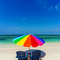 Buy canvas prints of Bahamas beach umbrella and chairs on sandy beach  by Spotmatik 