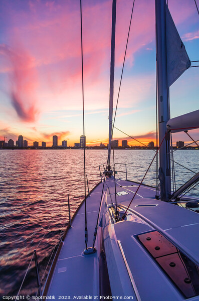 Sailing luxury yacht at sunset with cityscape view Picture Board by Spotmatik 