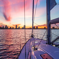 Buy canvas prints of Sailing luxury yacht at sunset with cityscape view by Spotmatik 