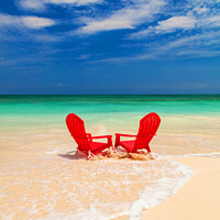 Buy canvas prints of Red chairs on shoreline of sandy beach Bahamas by Spotmatik 