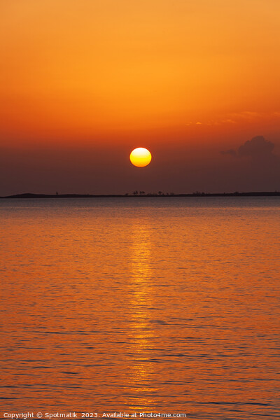 Orange sky with sunset reflection on tropical ocean Picture Board by Spotmatik 