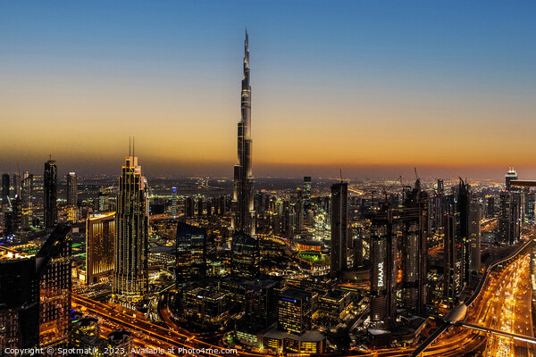Aerial illuminated Dubai at sunset Burj Khalifa UAE Picture Board by Spotmatik 